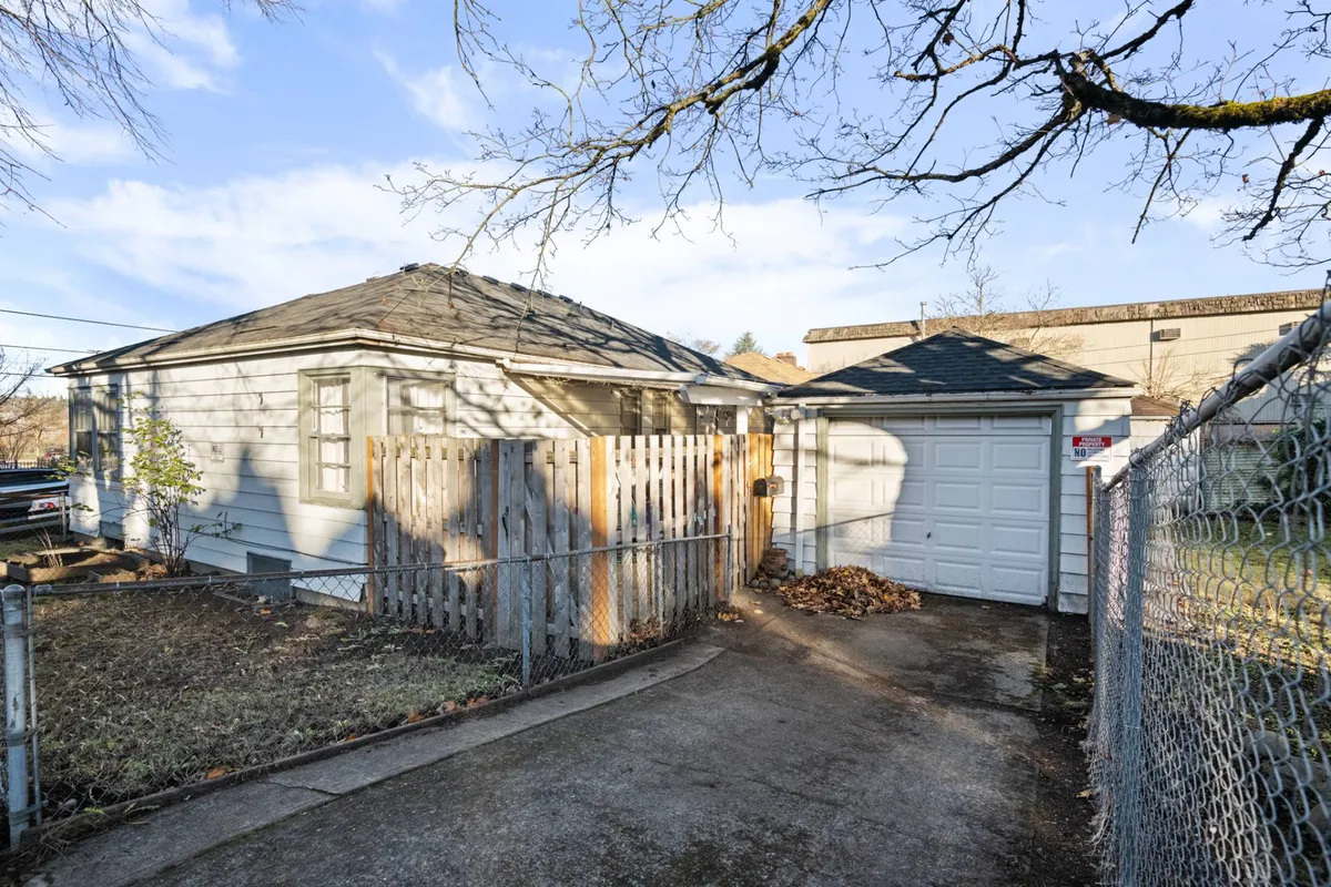 A welcoming view of the house exterior featuring a fenced yard, garage, and inviting porch. The neighborhood feels peaceful and residential, emphasizing privacy and a family-friendly environment.